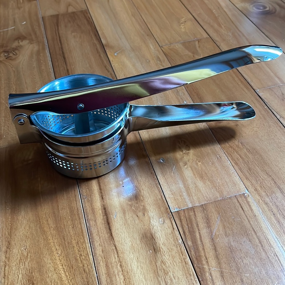 Metal potato ricer masher. Easy squeeze handle, easy clean and dishwasher safe
